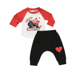 Baby boy Valentine's Day 2-piece outfit featuring a red and white long sleeve shirt with a truck print and black jogger pants with a red heart.