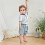 Close-up of soft waffle knit button short sleeve bodysuit from baby boy summer outfit set