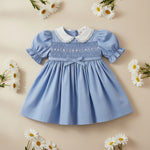 Toddler girls special occasion dress with lace crew neck and smocked bodice.