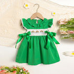 Close-up of ruffle sleeve and bow detail on toddler girls green dress