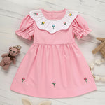 Toddler baby girl wearing a tulip embroidered smocked princess dress for spring and summer.