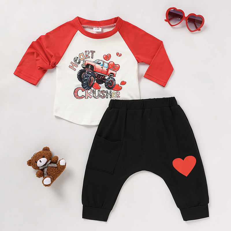 Flat lay view of the 2-piece baby boy 'Heart Crusher' Valentine's Day clothing set including top and pants.