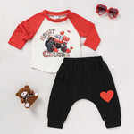 Flat lay view of the 2-piece baby boy 'Heart Crusher' Valentine's Day clothing set including top and pants.