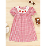 Cute toddler girls back to school dress featuring plaid print and smocked detailing