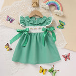 Side view of toddler girls green A-line dress with ruffle sleeves and bow accent